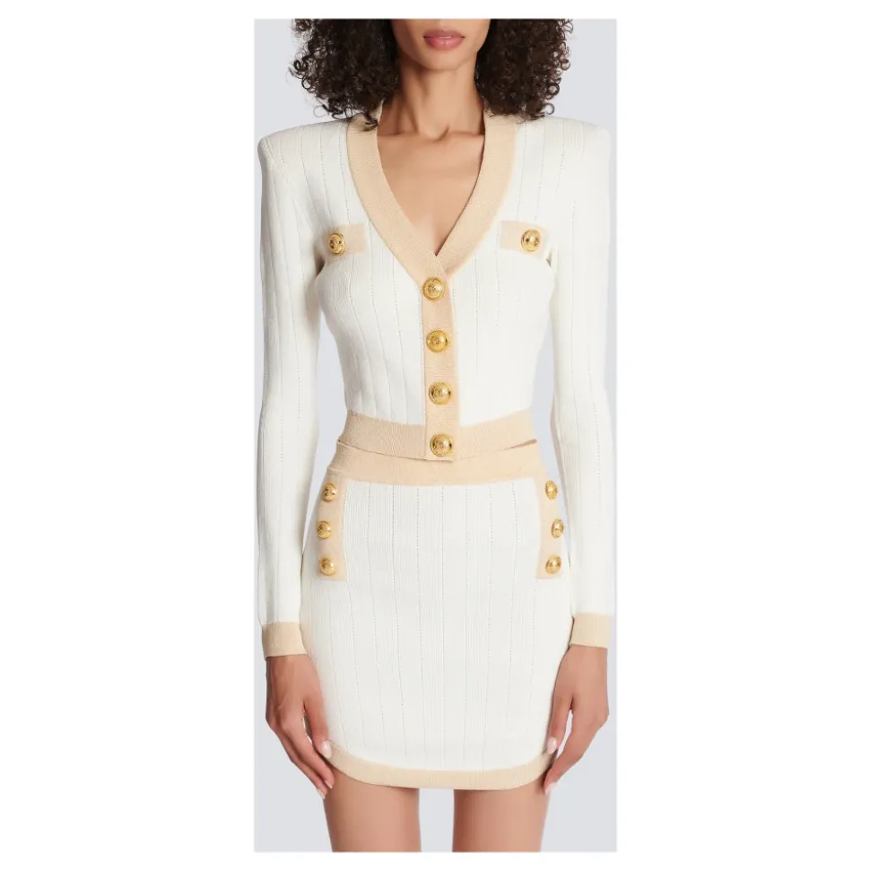 Cardigan court en maille à bordures dorées